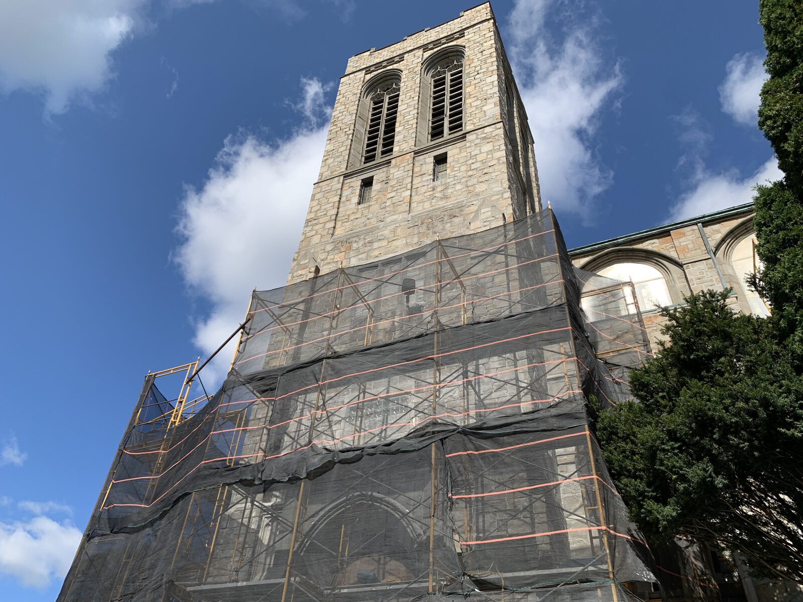 The historic tower surrounded by scaffold and protective netting