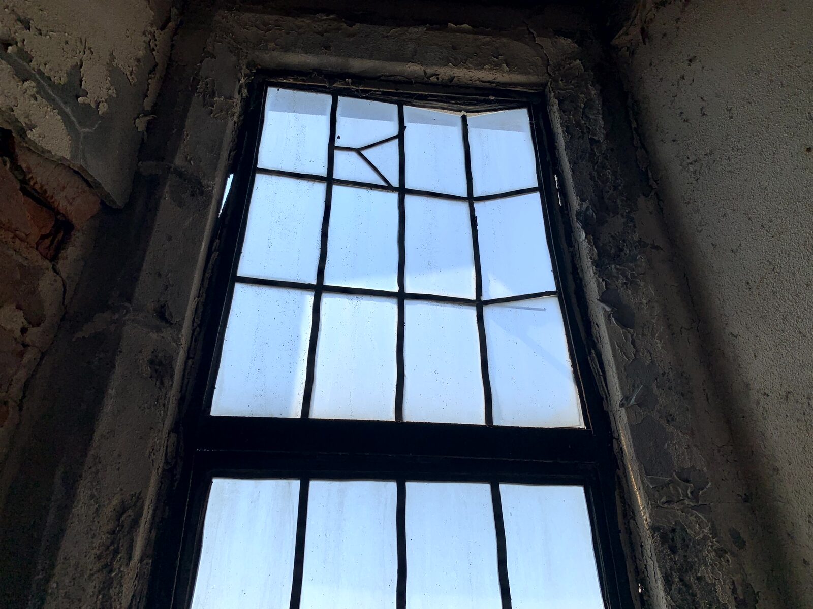 Interior view of an aged tower window and surrounding wall