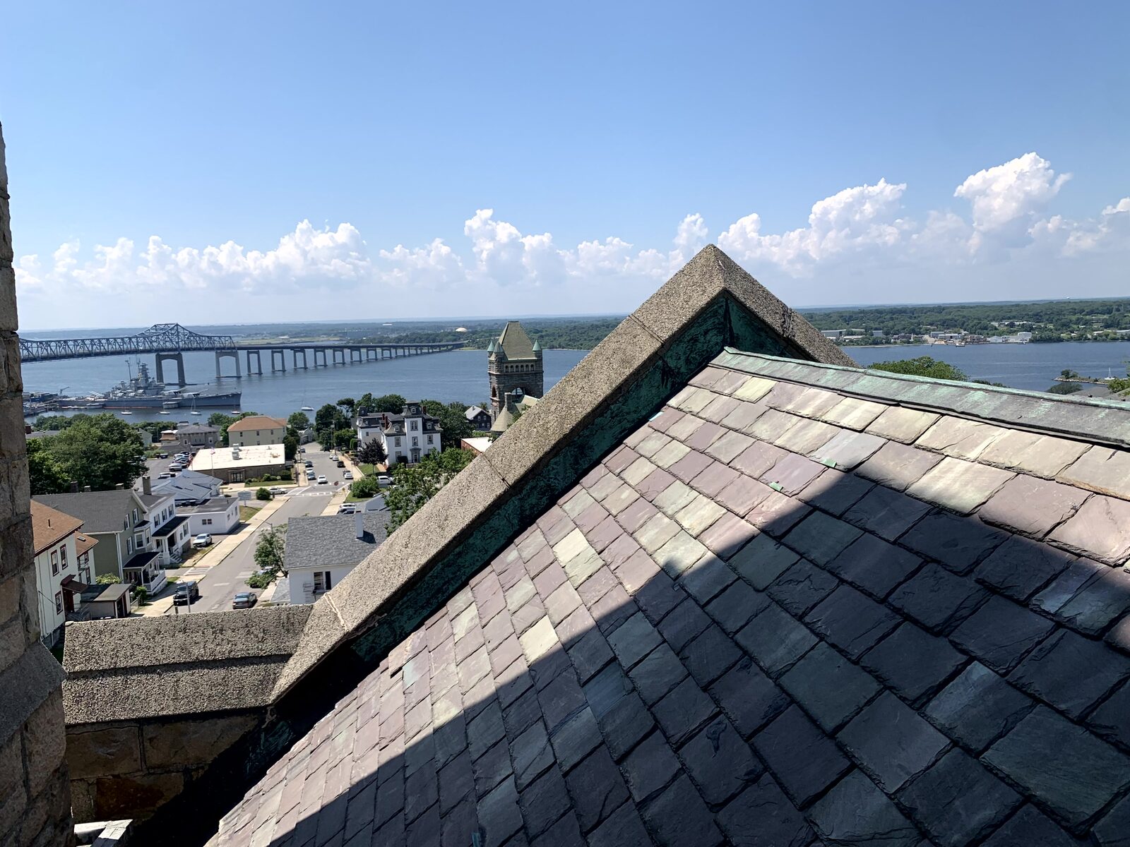 High view across the church roofline toward Fall River and the Braga Bridge