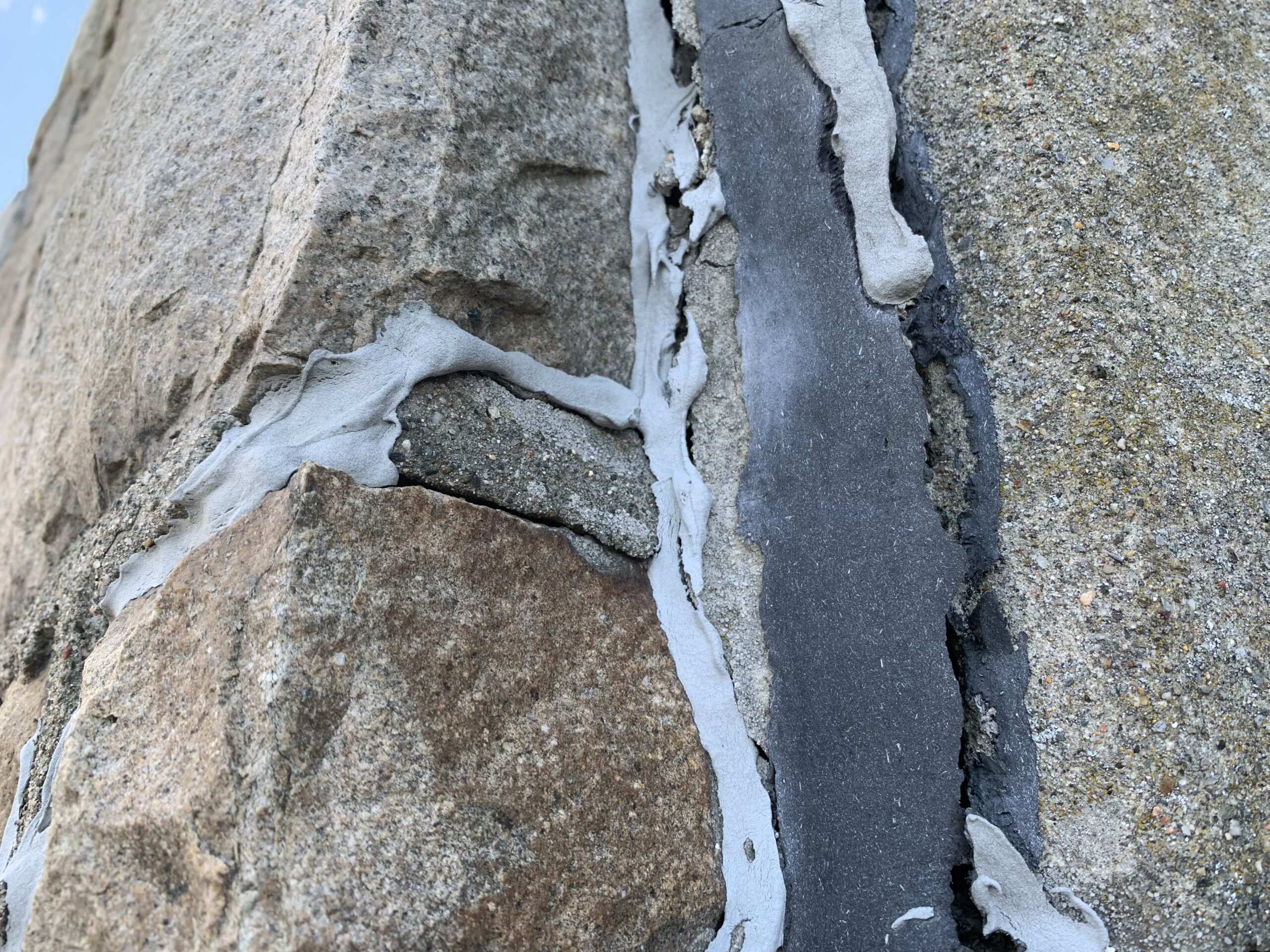 Close view of deteriorated masonry joints on the church tower